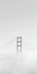 the Golden Gate Bridge in fog, captured from a distance. The mist creates a soft