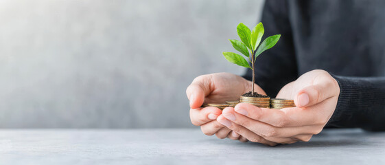 Hand nurturing green plant with soil and investment growth concept