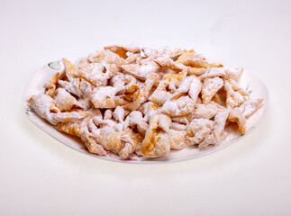 Angel wings (Faworki), cakes. Sweet pastry deep fried and sprinkled with powdered sugar