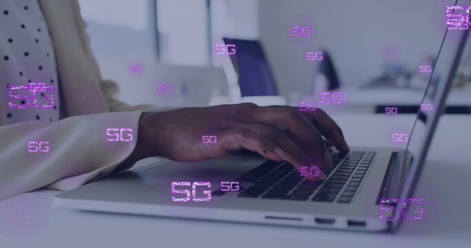 Image of 5g text and data processing over afrcian american businesswoman using laptop