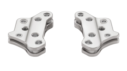 Closeup of two shiny silver metal pedals on a green plaid background, perfect for automotive, music, or industrial design