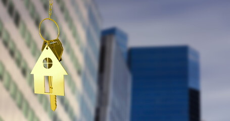 Image of key and house over cityscape