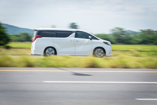 Nakhonsawan, Thailand - June 2024: A white Toyota Alphard runs at speed on a highway on June 24, 2024, in Nakhon Sawan, Thailand.