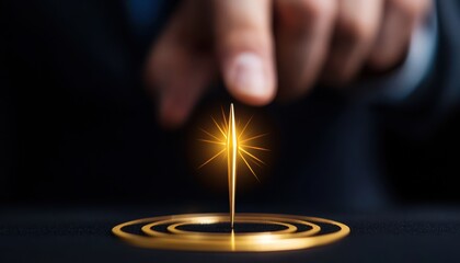 Obraz premium A hand pointing at a glowing golden spark on a dark surface, symbolizing innovation.