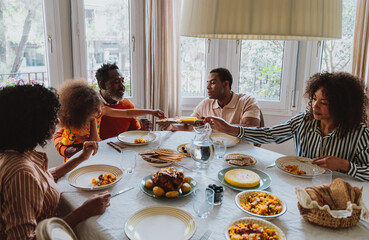 Storytelling image of a Family reunited at parents house  for lunch on the holidays. Family members...