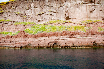 Volcanic rock nature. Rock formation with erosion. Landscape with rock. Nature formation. Geological rock formation. Tourism and travel destination, Greece. Geology. Wave-sculpted formation