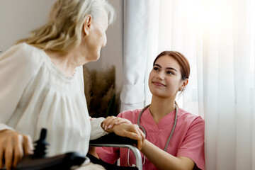 Caucasian caregiver lady consulting with elderly woman patient. Wheelchair disability rehabilitation and nurse at nursing home. Healthcare support and caregiver with senior woman for medical help.