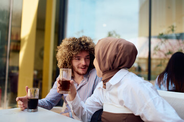 A European man with an Afro American hairstyle enjoys a drink with his Muslim friend in a cozy outdoor cafe.