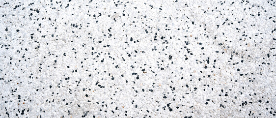 white background with the texture of black stones on the pavement