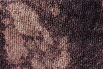 Close-up of cotton fabric texture with faded spots