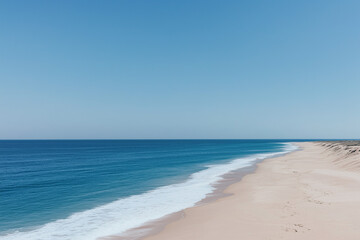Obraz premium Azure Horizon: An idyllic aerial shot of a serene beach stretches toward the horizon, where the azure sea meets a clear, boundless sky.