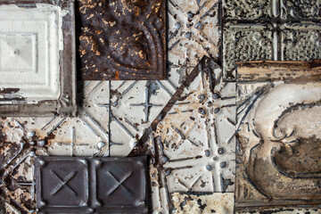 Vintage tin ceiling tiles with a white, chipped paint finish
