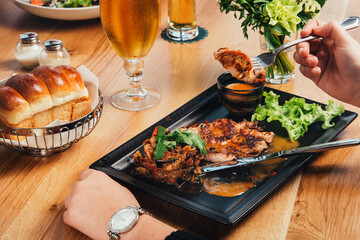 Grilled chicken fillet meat with vegetable garnish t at restaurant, close up view.