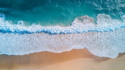 Turquoise Waves Crashing on Golden Sand: Aerial Beach View