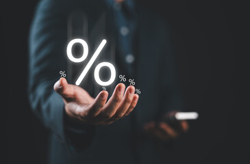 Businessman holding percentage symbol for financial banking increase interest rate or mortgage investment dividend from business growth concept. Economic recession. Interest rate burden.