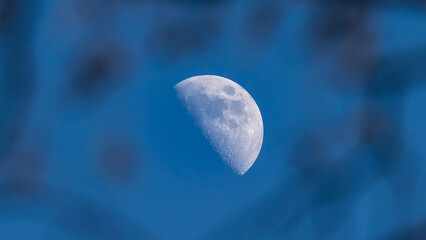 Close-up shot of the moon in the blue sky