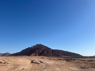 Rocks in the desert with sand of Egypt blue sky and sun