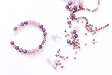 Preparing gemstone jewelry. Natural stones pink quartz, Amethyst, silver. Craft, handmade conception. Free space for text.