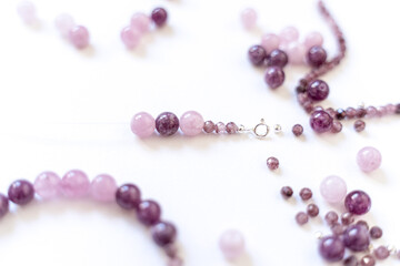 Preparing gemstone jewelry. Natural stones pink quartz, Amethyst, silver. Craft, handmade conception. Free space for text.