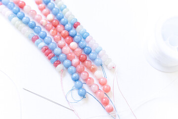 Preparing gemstone jewelry. Natural stones , needle, elastic silicone. Craft, handmade conception. Free space for text.