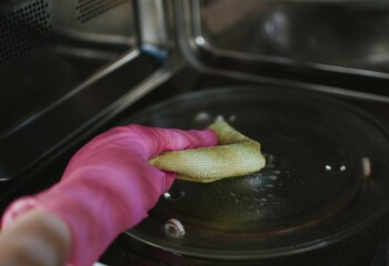 Cleaning the microwave with detergent and a cloth