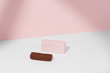 Pink mockup box and chocolate bar on pink and white isolated background with shadow. Concept of sweets product advertising, confectionery packaging. Template for your design