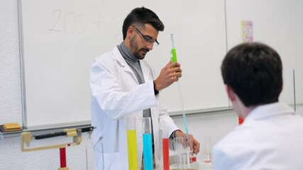 Chemistry teacher performing experiment for students in laboratory