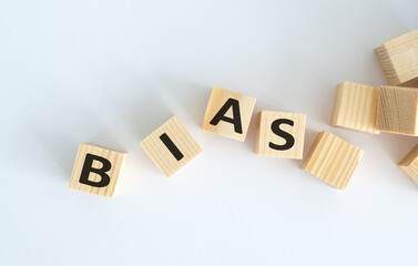 A wooden block with the letters B, I, A, S, and S written on it