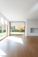 Fototapeta premium Bright modern living room with large windows overlooking a lush garden in autumn