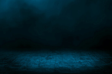 concrete floor with dark blue background and blue smoke float above. abstract image featuring a...