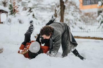 Two friends enjoying winter by playing in the snow in a cheerful and energetic manner. The outdoor...
