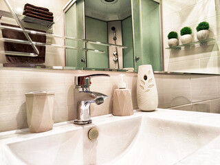 Modern bathroom sink with stylish decor and fresh greenery in a contemporary setting