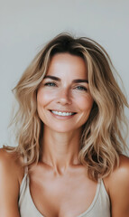 Fototapeta premium Portrait of a radiant woman with a genuine smile, showcasing natural beauty and confidence
