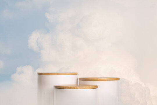 Minimal geometry cylinder podium stage with blue sky white fluffy clouds background.product placement pedestal modern stand display,surreal paradise dreamy concept.