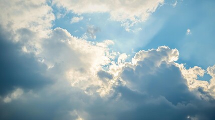 Obraz premium Cloudy sky background with thick, fluffy clouds in varying shades of blue, gray and white