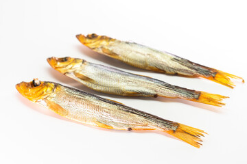 Hot smoked whole herrings on kitchen table. smoked fish isolated on white