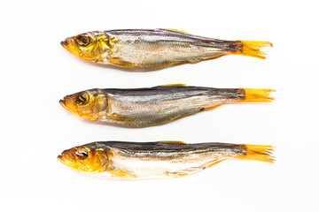 Hot smoked whole herrings on kitchen table. smoked fish isolated on white