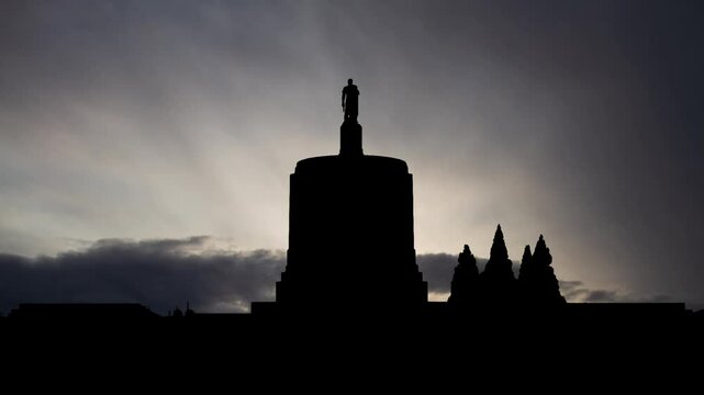 State Capitol in Oregon, Time Lapse at Sunrise with Fast Clouds and Dark Silhouette of building in Salem, USA