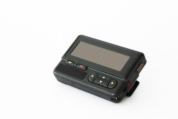 Vintage pager lying on a white surface showcasing retro technology and communication history