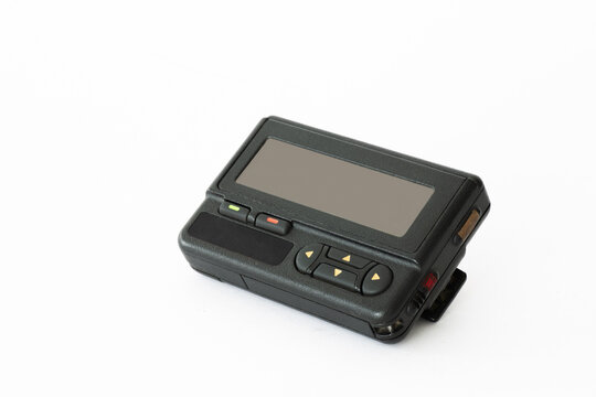 Vintage pager lying on a white surface showcasing retro technology and communication history