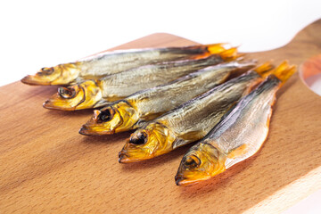Hot smoked whole herrings on kitchen table. smoked fish isolated on a wooden background