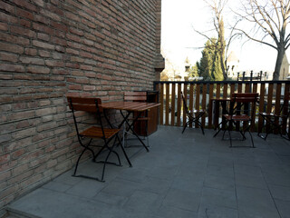 City cafe on street with wooden chairs and tables