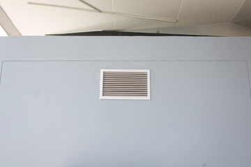 Aluminum ventilation vents installed on gray walls.