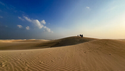 Breathtaking Socotra landscape with camel riders exploring vast sand dunes under a clear sky