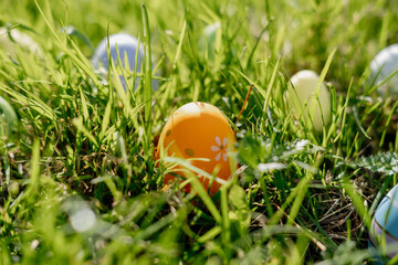 Happy Easter. Easter eggs on grass on a sunny spring day - Easter decoration, banner, panorama, background with copy space for text.