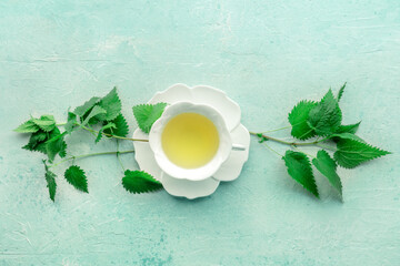 Nettle tea. Medicinal herbal tea with Urtica leaves. Fresh wild herb, shot from the top with a place for text