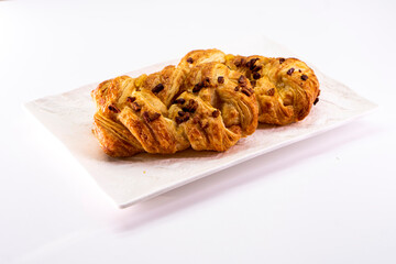 Fresh delicious puff pastry with maple syrup and nuts on white background