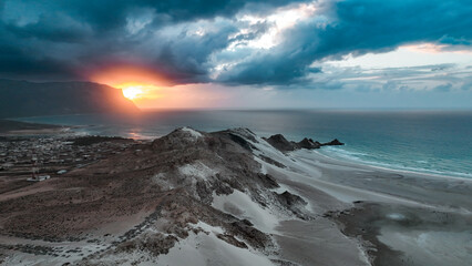 Stunning sunset over sandy beaches and rugged mountains of Socotra Island