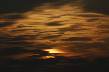 a sunset seen in the sky over a rice field in nakhon sawan province, north of bangkok on february 23, 2025..