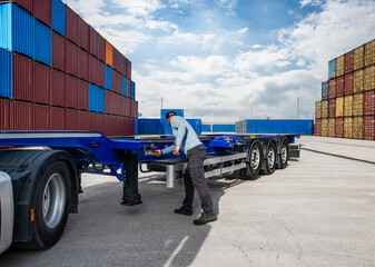 A man is working on a truck in a warehouse